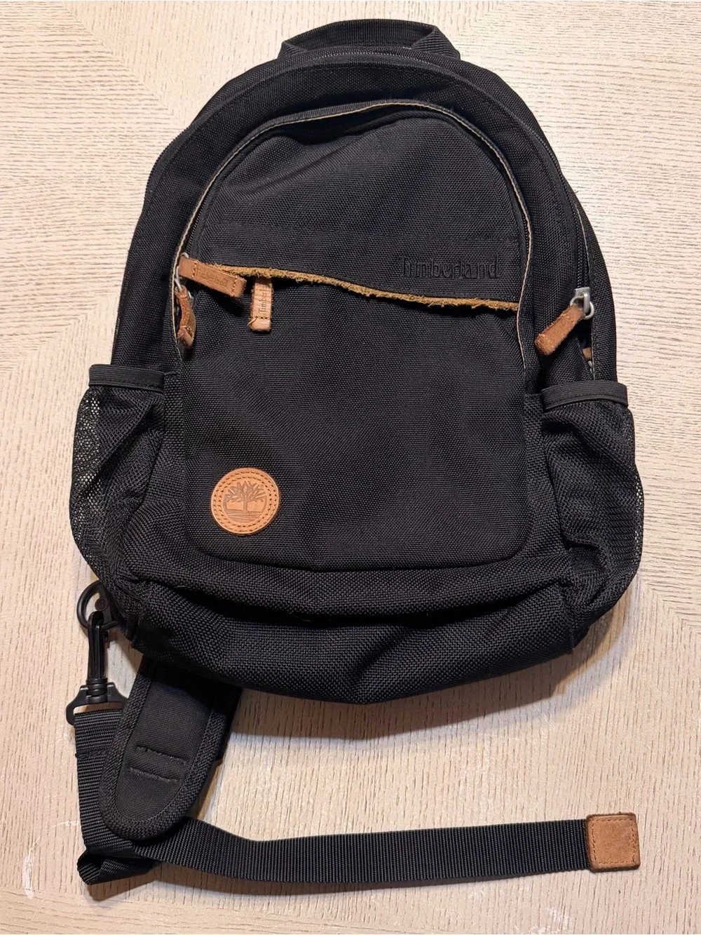 Timberland Black Sling Backpack with Brown Leather Accents
